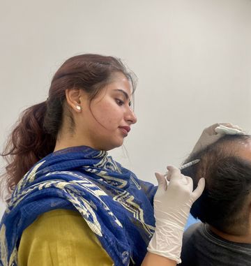 Dermatologist administering a scalp injection for hair restoration