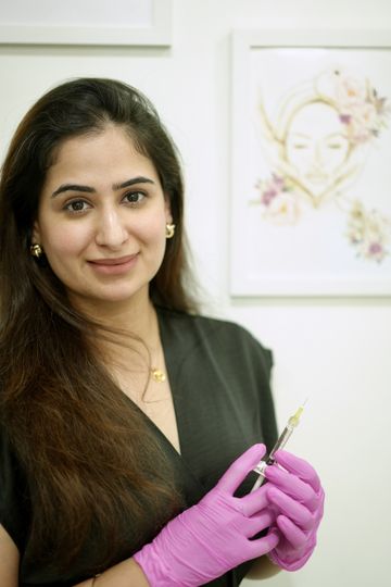 Dr. Sonia holding an injectable anti-ageing treatment
