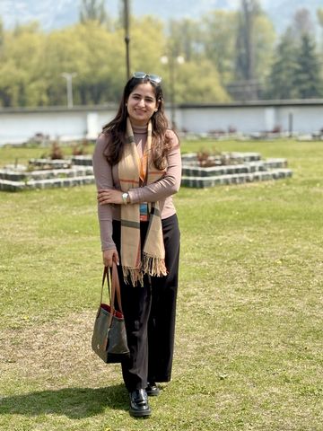 Dr. Sonia outdoors at a medical conference venue