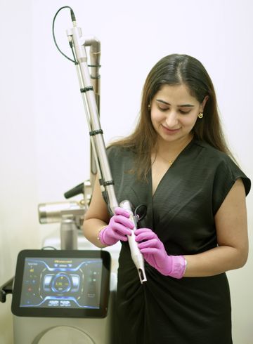 Dr. Sonia holding an advanced laser handpiece